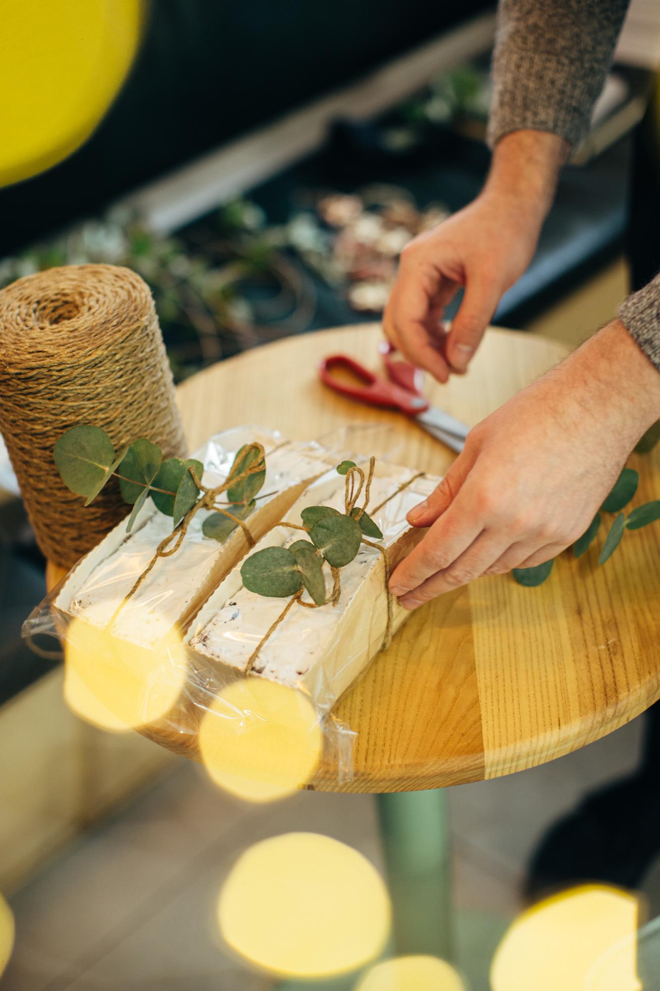 Hand selecting fresh herbs at market stall